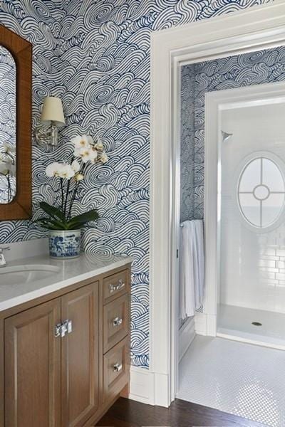 bathroom with wallpapered walls, wood finished floors, and vanity