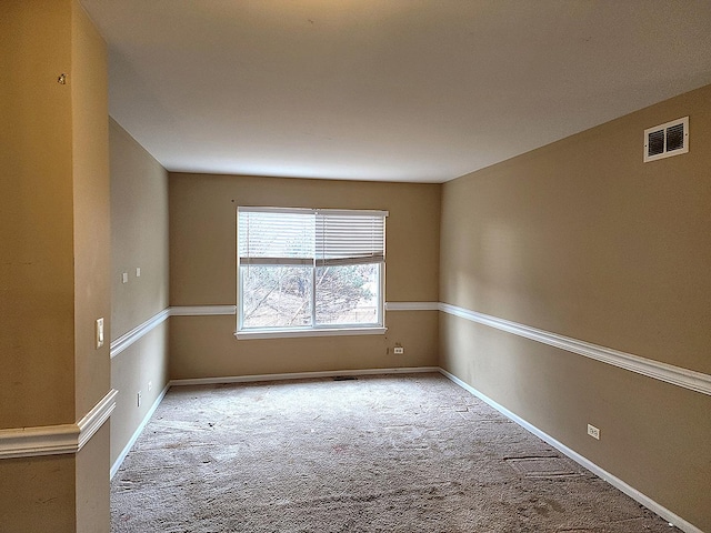 unfurnished room featuring visible vents, baseboards, and carpet floors