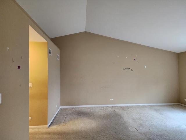 unfurnished room with baseboards, lofted ceiling, and carpet floors