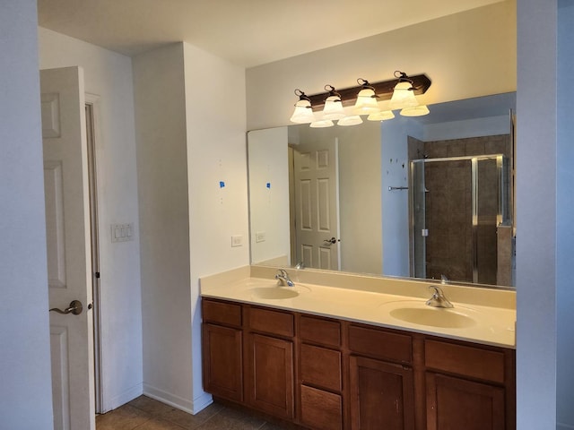 full bath featuring double vanity, tile patterned flooring, a shower stall, and a sink