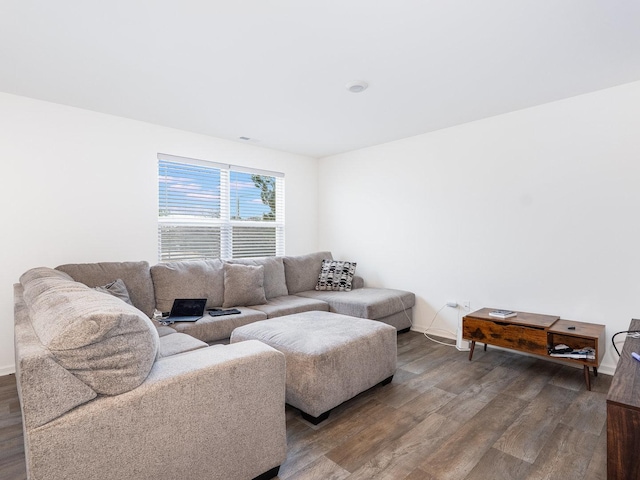 living area featuring baseboards and wood finished floors