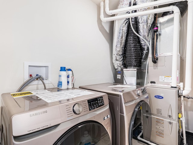 clothes washing area featuring laundry area and separate washer and dryer