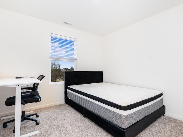 bedroom featuring visible vents, baseboards, and carpet