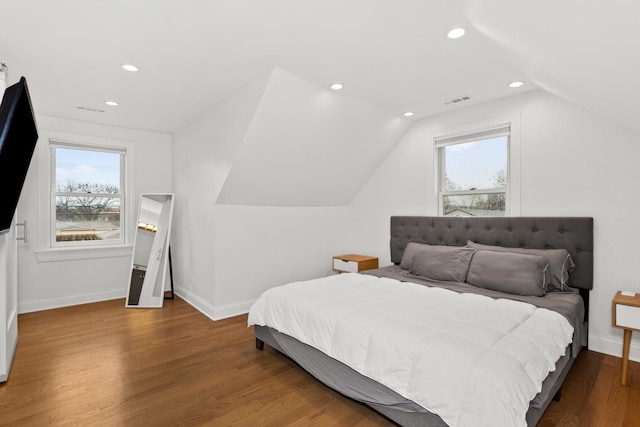 bedroom with lofted ceiling, recessed lighting, wood finished floors, and baseboards