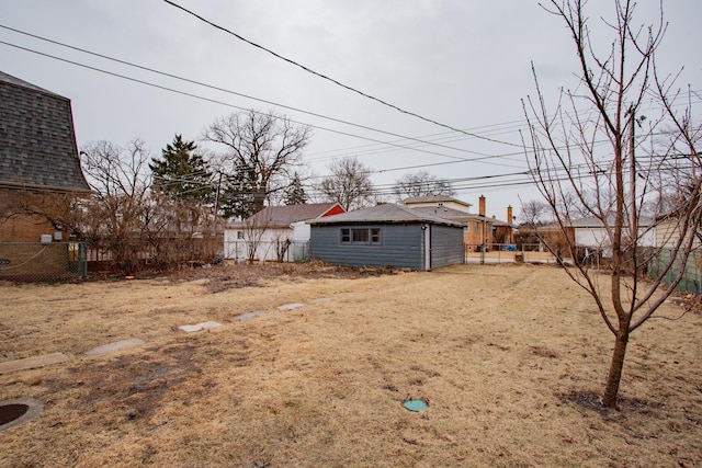 view of yard featuring fence and an outdoor structure