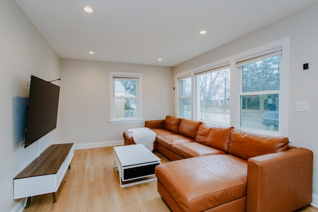 living room featuring baseboards, recessed lighting, and light wood-style floors