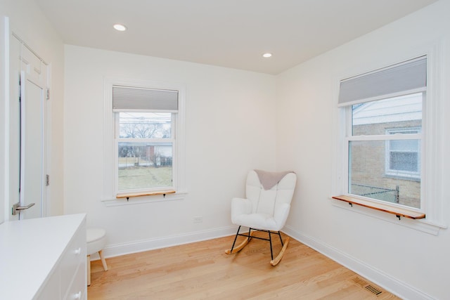 sitting room with baseboards, recessed lighting, and light wood-style floors