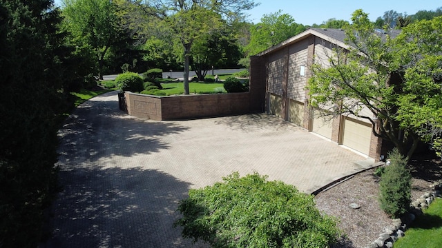 view of patio with decorative driveway and a garage