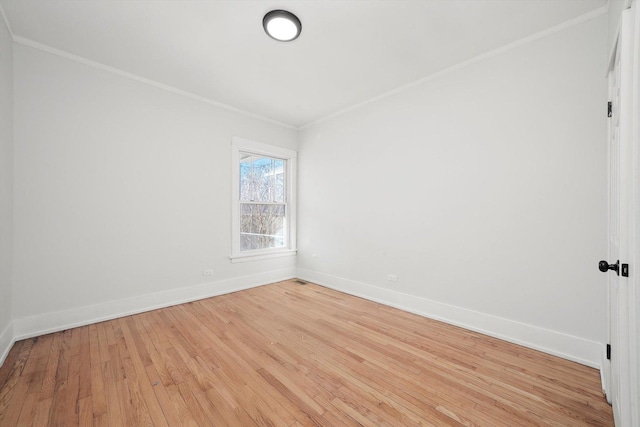 unfurnished room featuring light wood-style flooring, crown molding, and baseboards