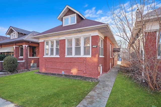 view of front of house with brick siding and a front lawn