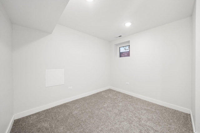 carpeted empty room featuring recessed lighting, visible vents, and baseboards