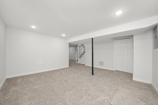 finished basement featuring visible vents, baseboards, stairway, carpet floors, and recessed lighting