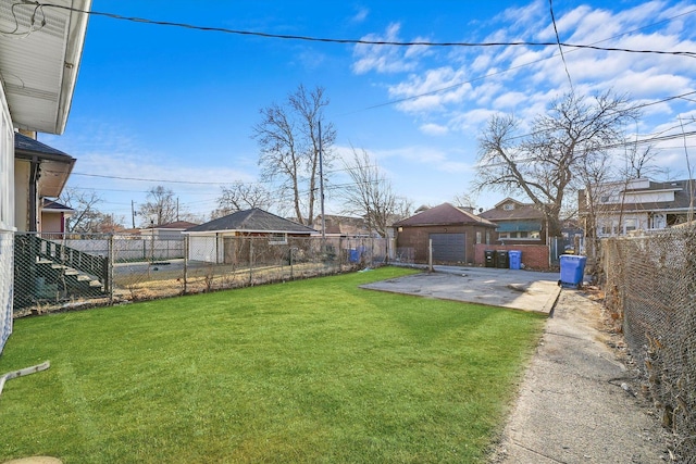 view of yard with a patio, an outdoor structure, a detached garage, and a fenced backyard