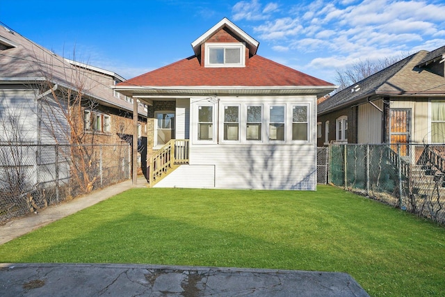 view of front of house with a front yard and fence