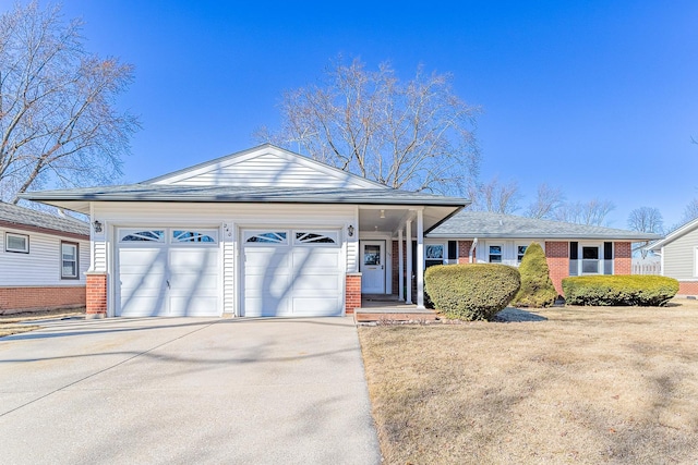 ranch-style house featuring a garage, concrete driveway, and brick siding