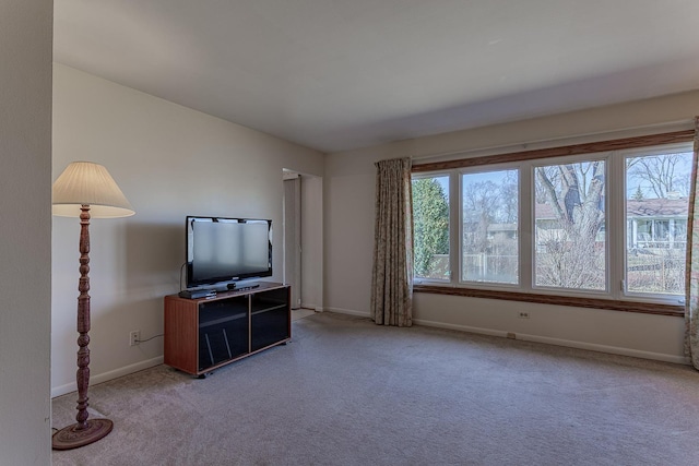 living area featuring carpet and baseboards