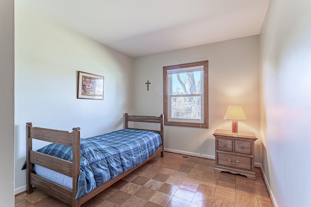 bedroom with baseboards and visible vents