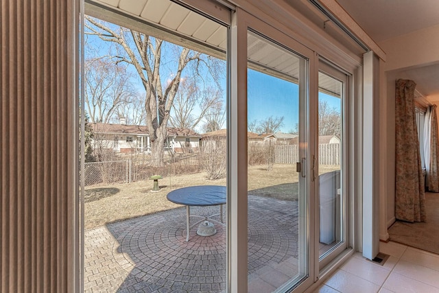 doorway to outside with tile patterned floors