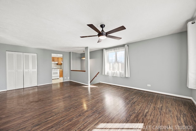 unfurnished bedroom with dark wood-type flooring, ceiling fan, and baseboards