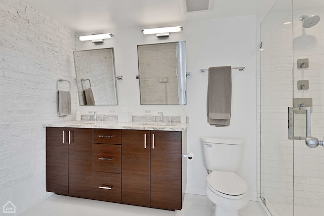 bathroom featuring double vanity, visible vents, toilet, a stall shower, and a sink