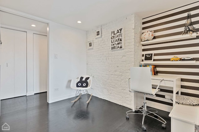 office area featuring baseboards, brick wall, wood finished floors, and recessed lighting