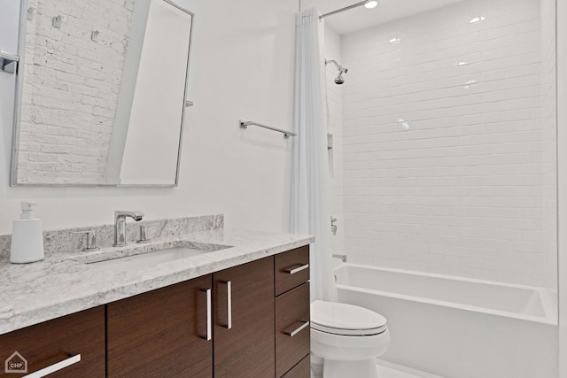 full bath featuring toilet, vanity, and bathing tub / shower combination