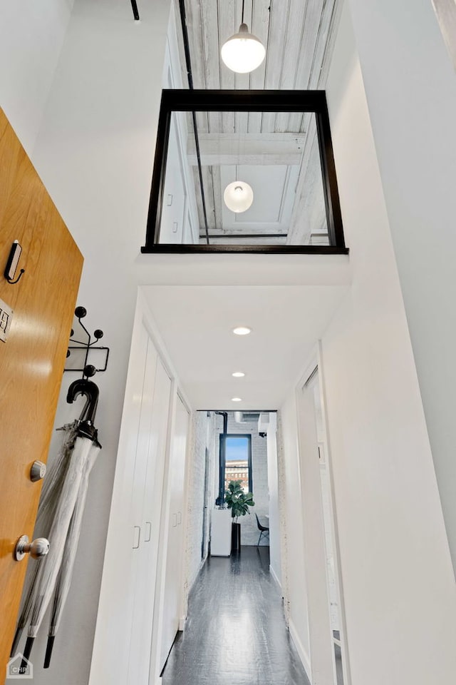 hall featuring a high ceiling and wood finished floors