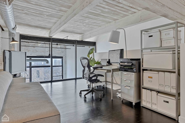 office space featuring dark wood-style floors, expansive windows, and beamed ceiling