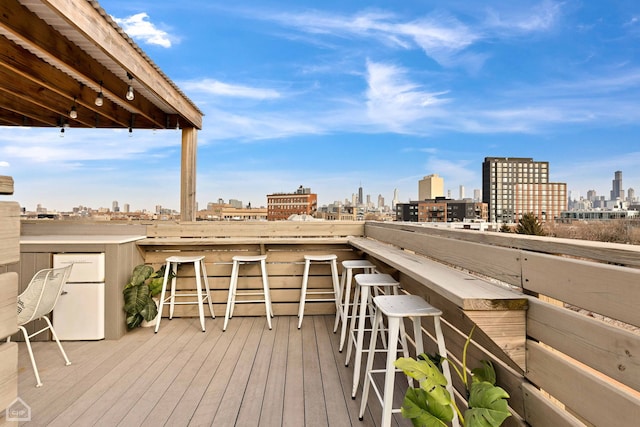 wooden deck featuring a view of city and outdoor dry bar