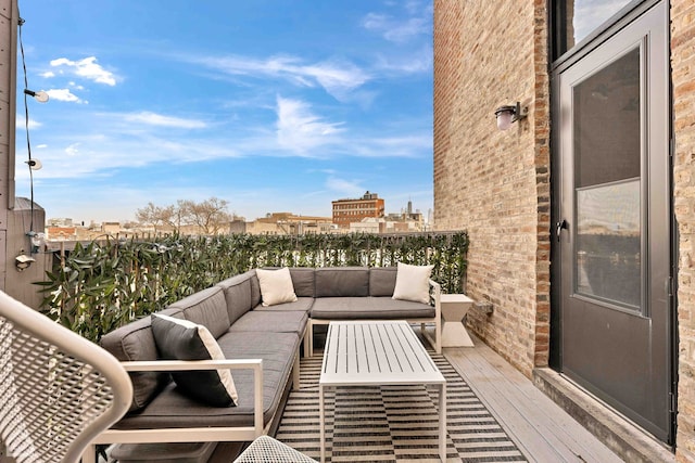 balcony featuring an outdoor living space and a city view