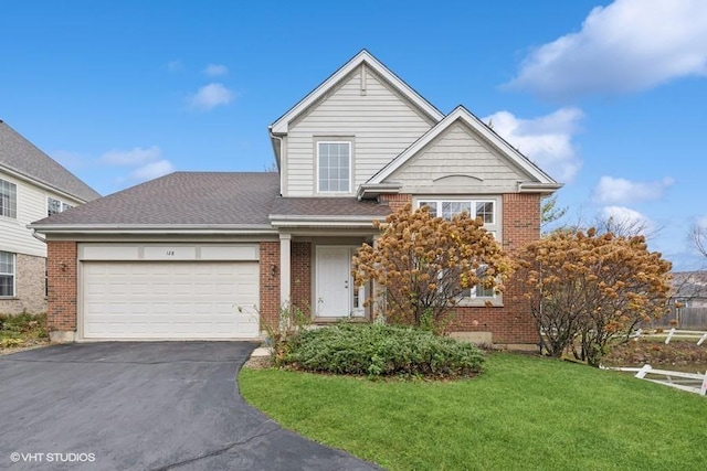 traditional-style house featuring a garage, aphalt driveway, and brick siding