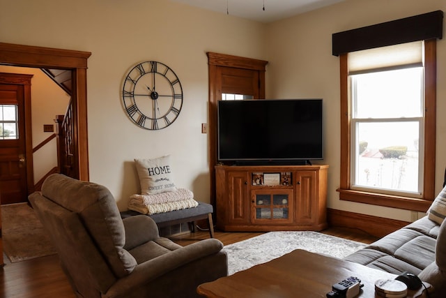 living area featuring stairway and wood finished floors