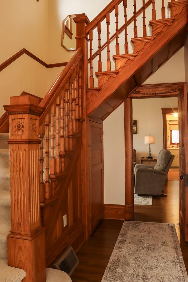 stairs featuring visible vents and wood finished floors