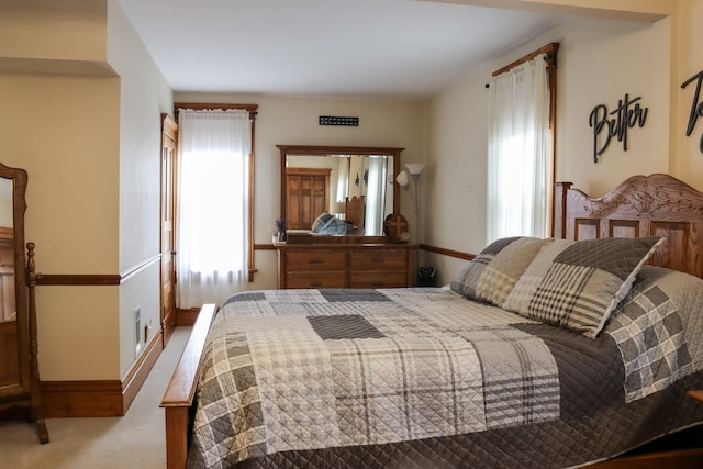 carpeted bedroom featuring baseboards