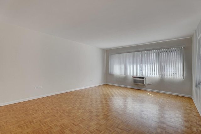 401 S Grove Ave Unit 2F, Oak Park, IL 60302 - spare room featuring baseboards and a wall mounted air conditioner