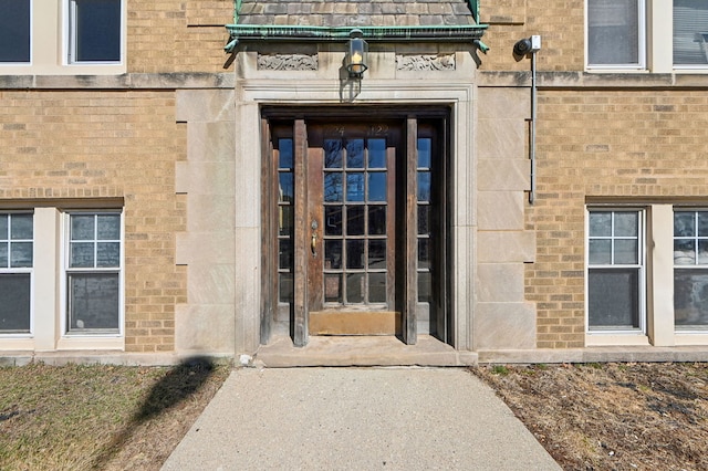 doorway to property with brick siding