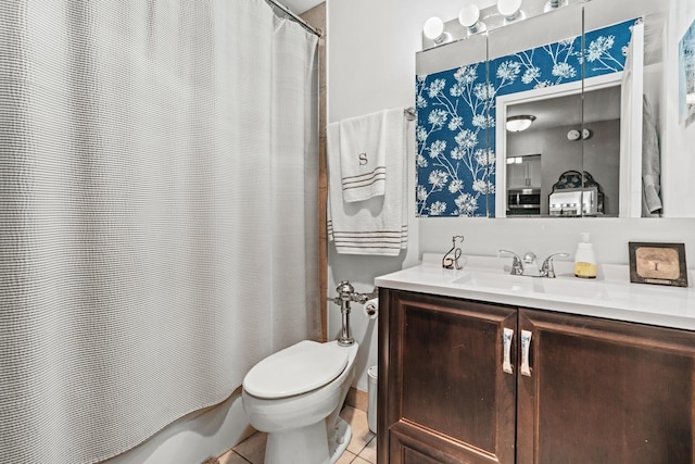 bathroom featuring tile patterned flooring, toilet, vanity, and shower / tub combo