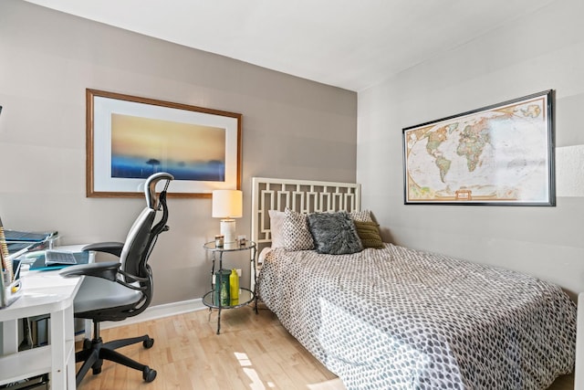 bedroom with wood finished floors and baseboards