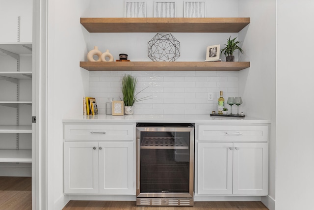 bar with wine cooler, tasteful backsplash, and a dry bar