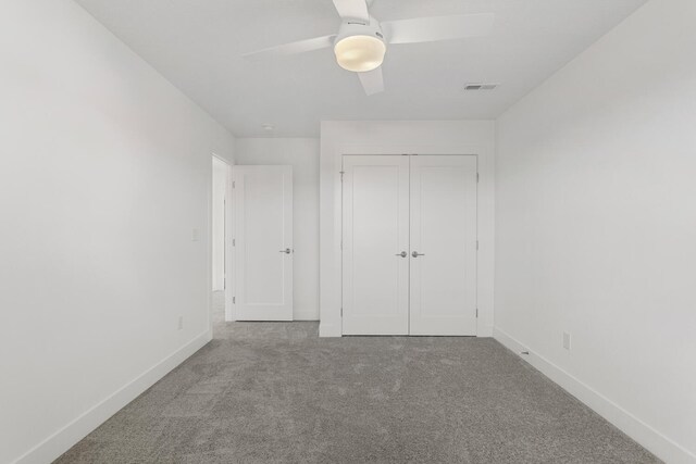 unfurnished bedroom with visible vents, baseboards, carpet flooring, a closet, and a ceiling fan