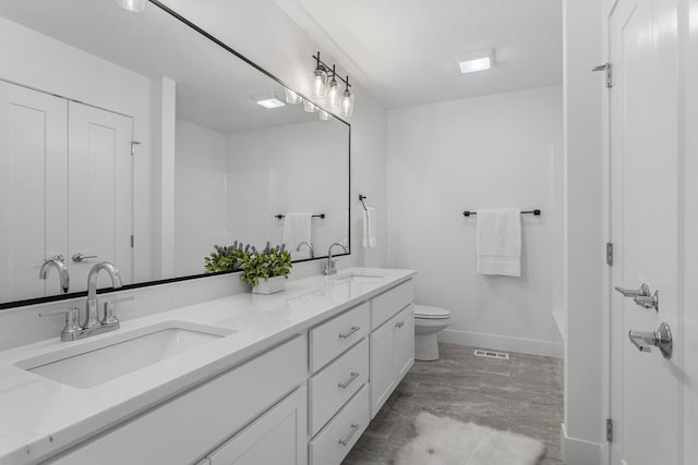 full bathroom featuring double vanity, visible vents, toilet, and a sink