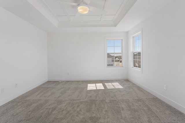 carpeted spare room with ceiling fan, coffered ceiling, and baseboards