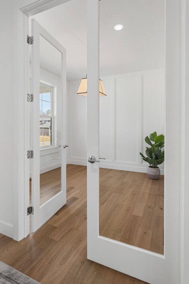 interior space with recessed lighting, french doors, and wood finished floors