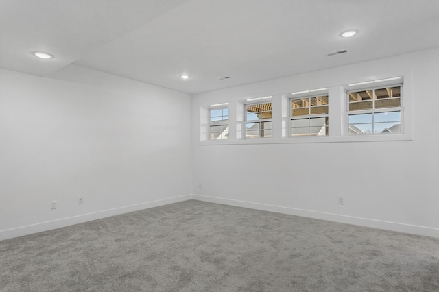 spare room with recessed lighting, visible vents, baseboards, and carpet flooring