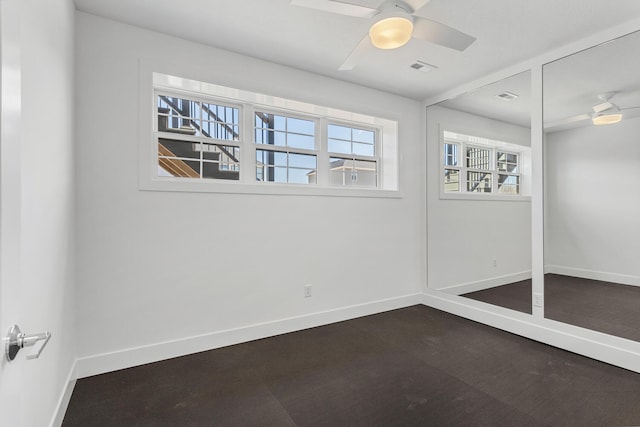 spare room featuring visible vents, baseboards, and ceiling fan