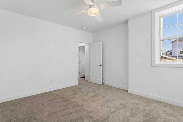 unfurnished bedroom with baseboards, a ceiling fan, and carpet flooring