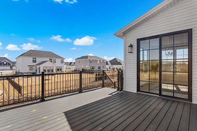 wooden deck with a residential view and fence