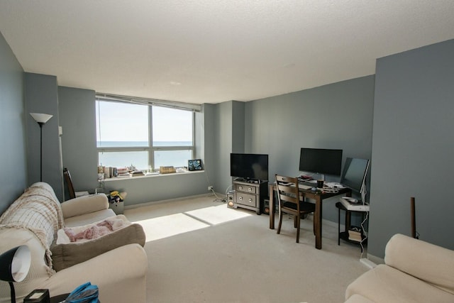 living area with baseboards and light colored carpet