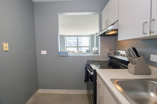 kitchen featuring under cabinet range hood, white cabinetry, stainless steel electric range oven, and baseboards