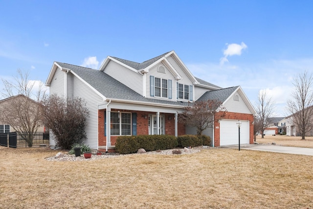 traditional-style home featuring a front lawn, fence, concrete driveway, a garage, and brick siding